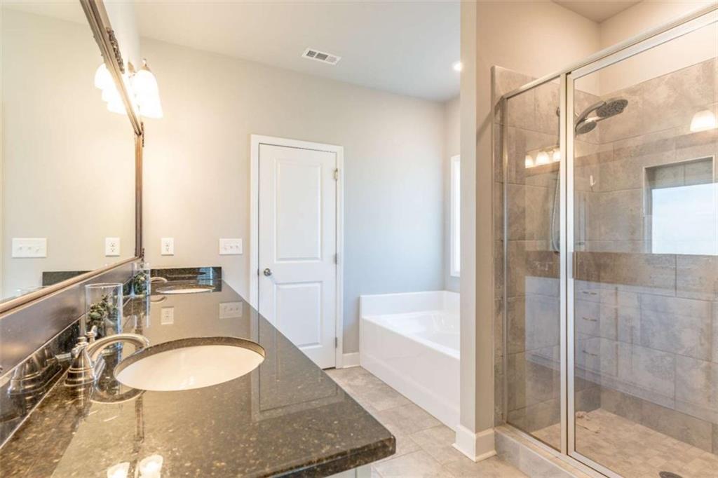 35 Hawthorn Lane Covington, GA 30014 - Photo 19 of 38 a bathroom with a granite countertop sink and a mirror
