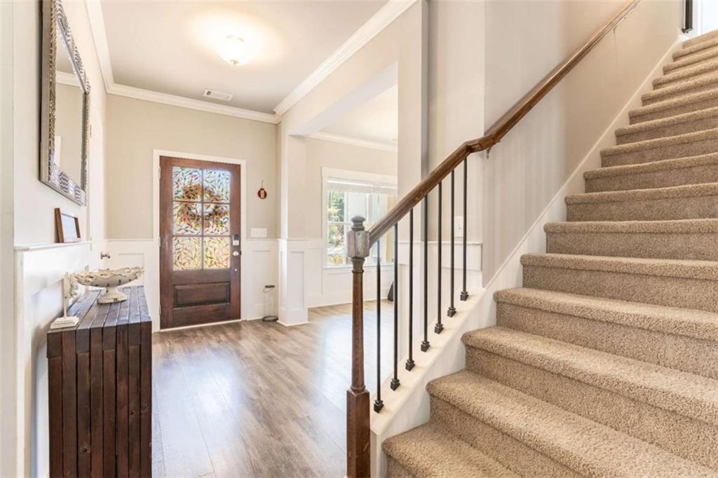 35 Hawthorn Lane Covington, GA 30014 - Photo 2 of 38 a view of a hallway with wooden floor and staircase
