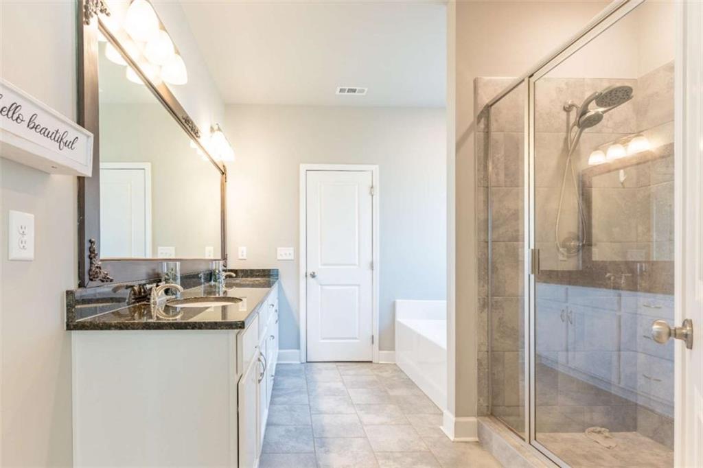 35 Hawthorn Lane Covington, GA 30014 - Photo 21 of 38 a bathroom with a granite countertop sink a mirror and a shower
