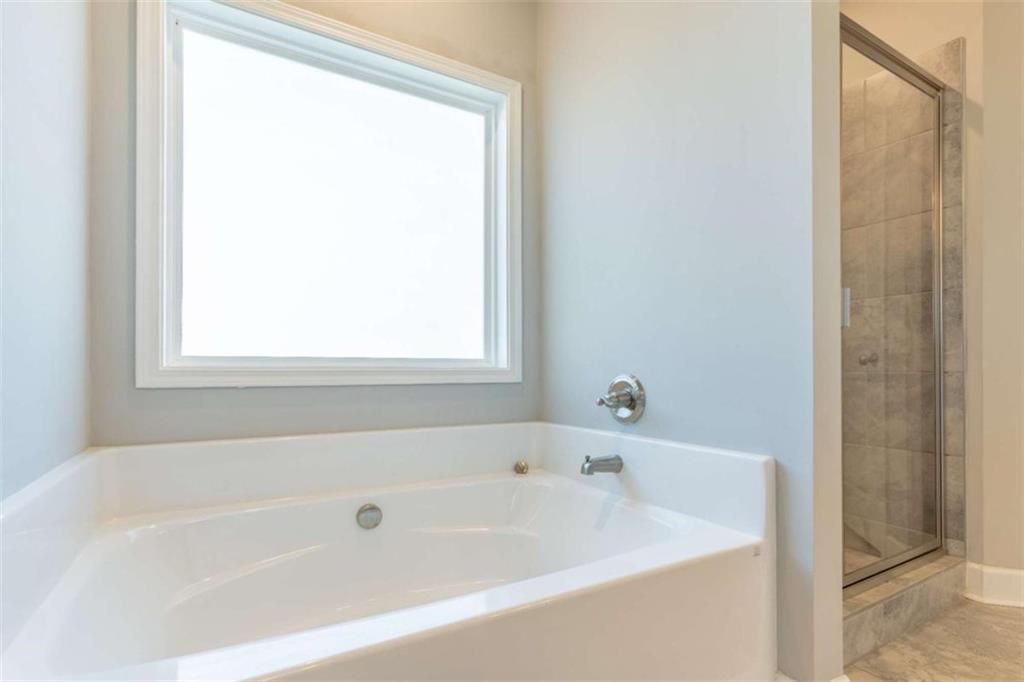 35 Hawthorn Lane Covington, GA 30014 - Photo 22 of 38 a white bath tub sitting next to a window