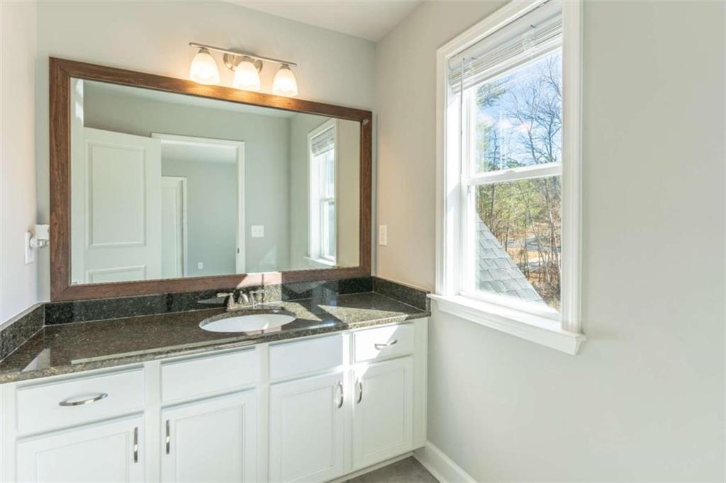 35 Hawthorn Lane Covington, GA 30014 - Photo 32 of 38 a bathroom with a granite countertop sink and a mirror