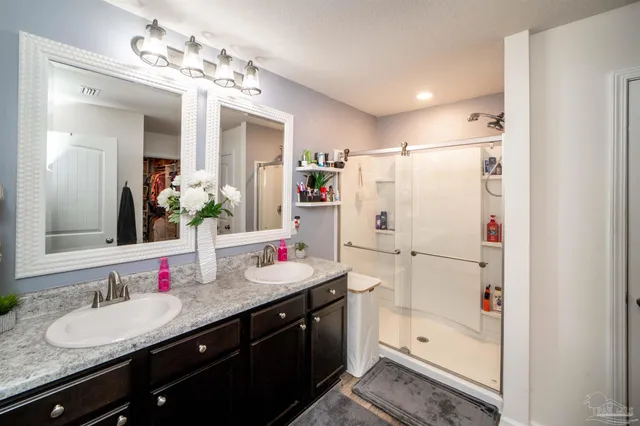 a white kitchen with a refrigerator sink and white cabinets