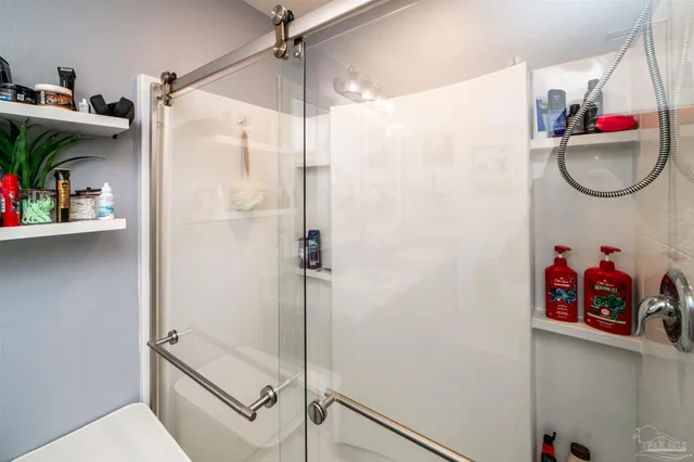 a bathroom with a shower and a sink
