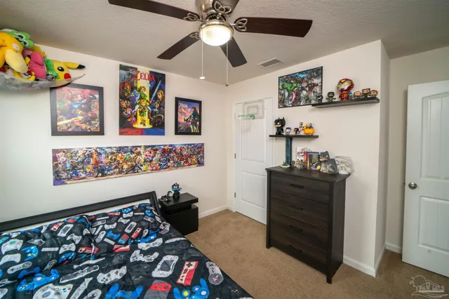 a bathroom with a toilet a sink and shower curtain