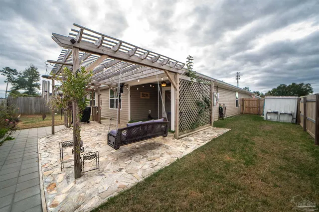 a backyard of a house with table and chairs