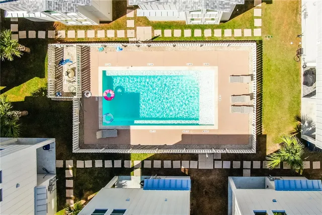 an aerial view of residential houses with outdoor space