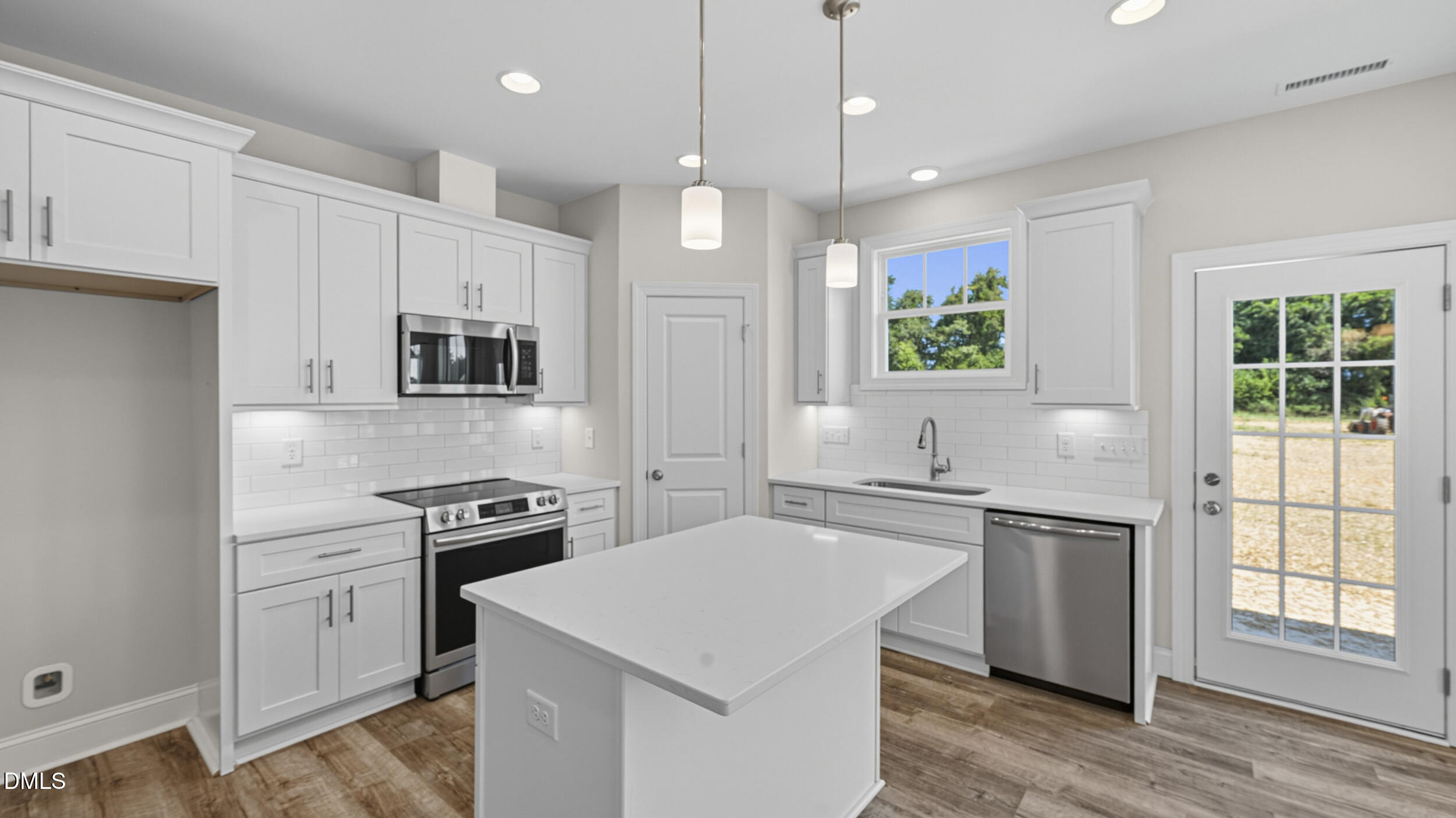 4105 Ralph Holt Court Snow Camp, NC 27349 - Photo 15 of 35 a kitchen with a stove a sink and a refrigerator