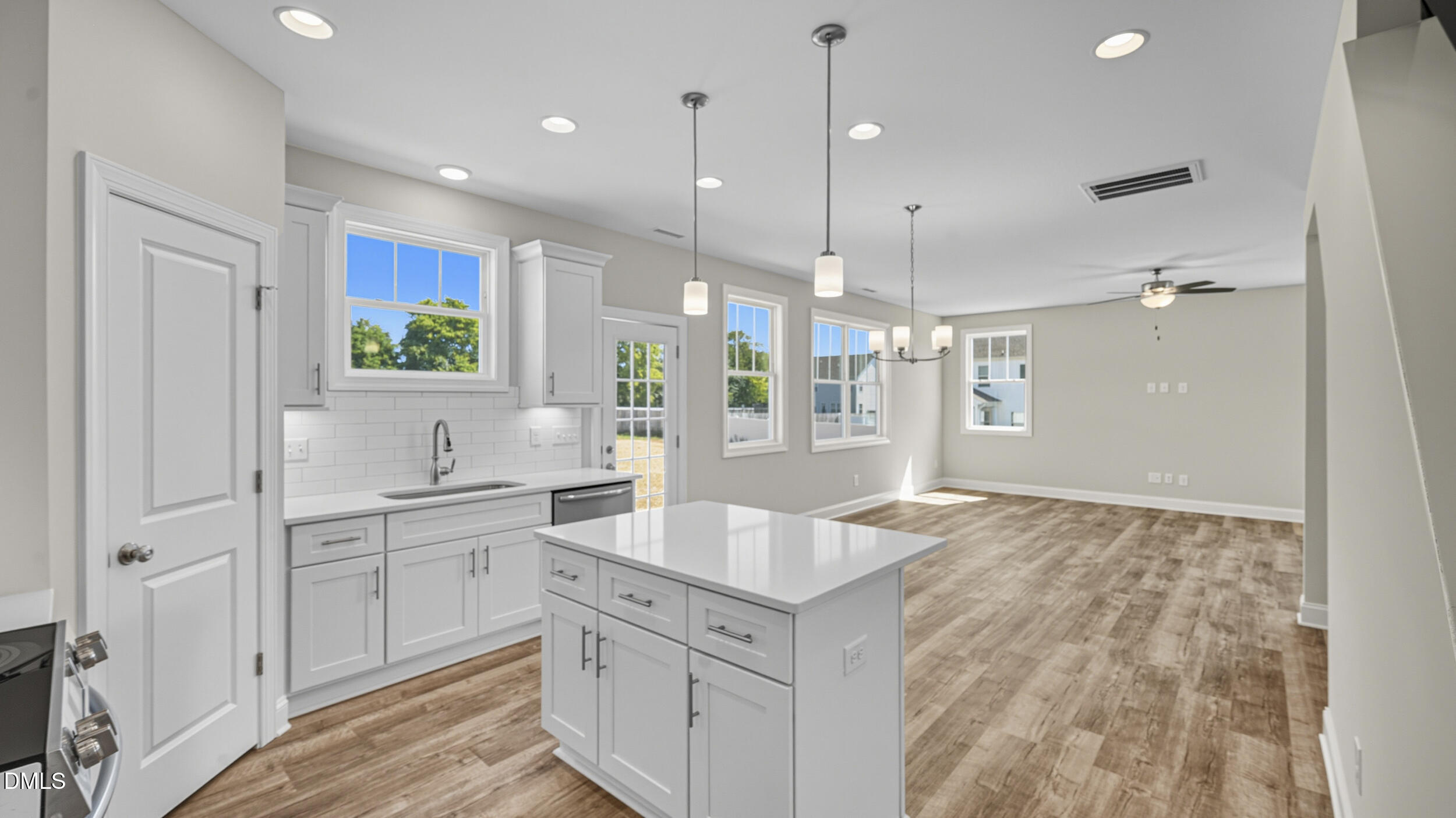 4105 Ralph Holt Court Snow Camp, NC 27349 - Photo 16 of 35 a large kitchen with kitchen island white cabinets and wooden floor