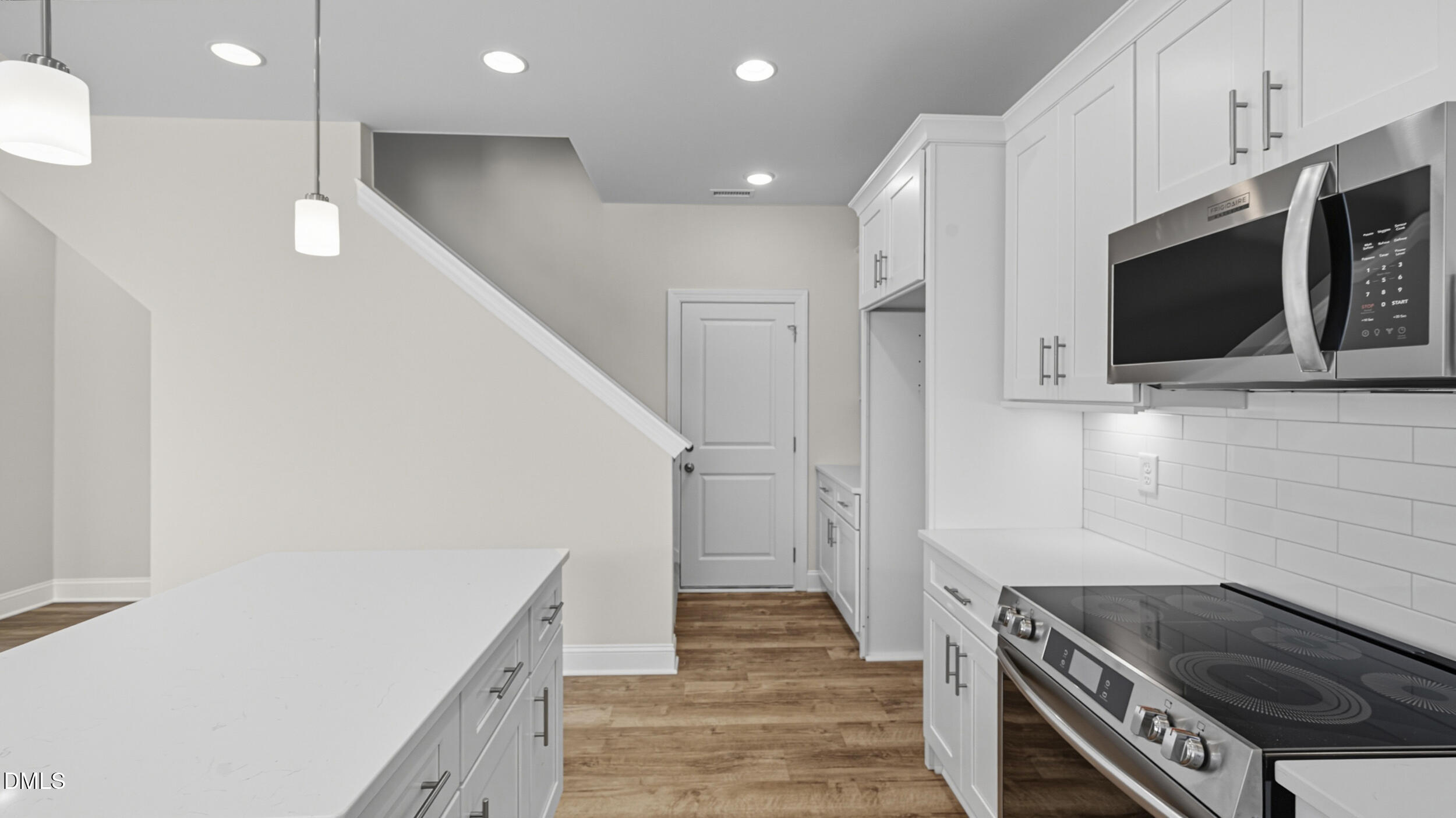 4105 Ralph Holt Court Snow Camp, NC 27349 - Photo 18 of 35 a kitchen with stainless steel appliances kitchen island granite countertop a stove and a microwave