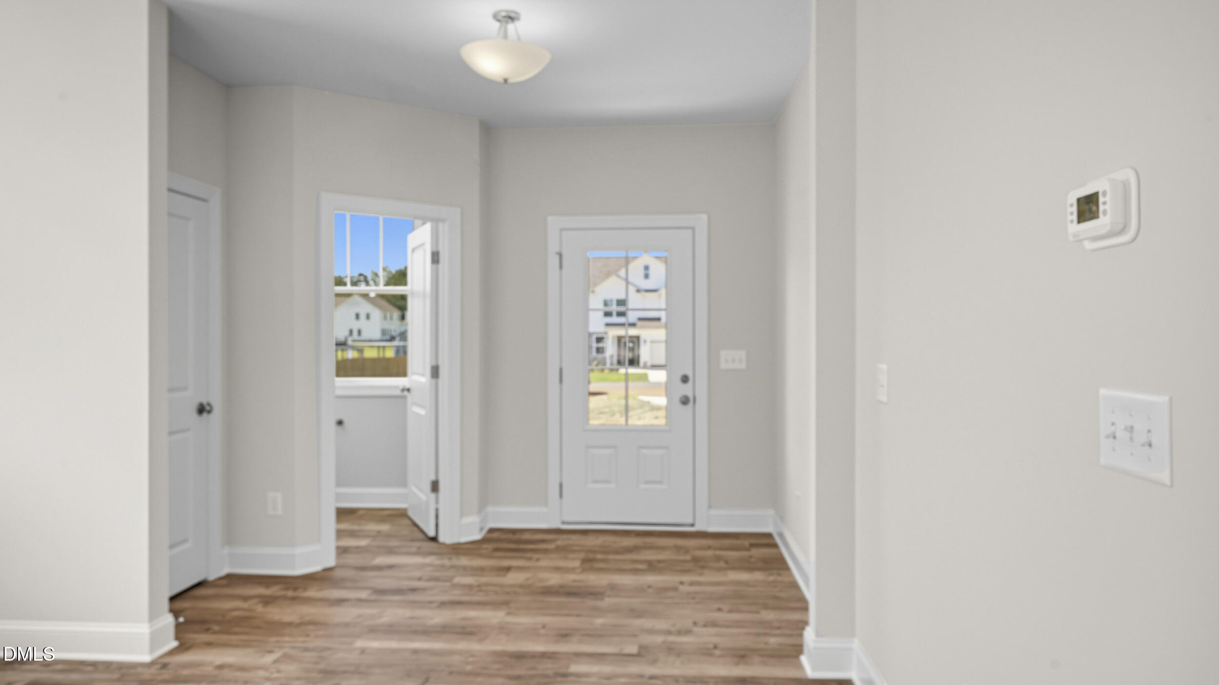 4105 Ralph Holt Court Snow Camp, NC 27349 - Photo 7 of 35 a view of an empty room with window and wooden floor