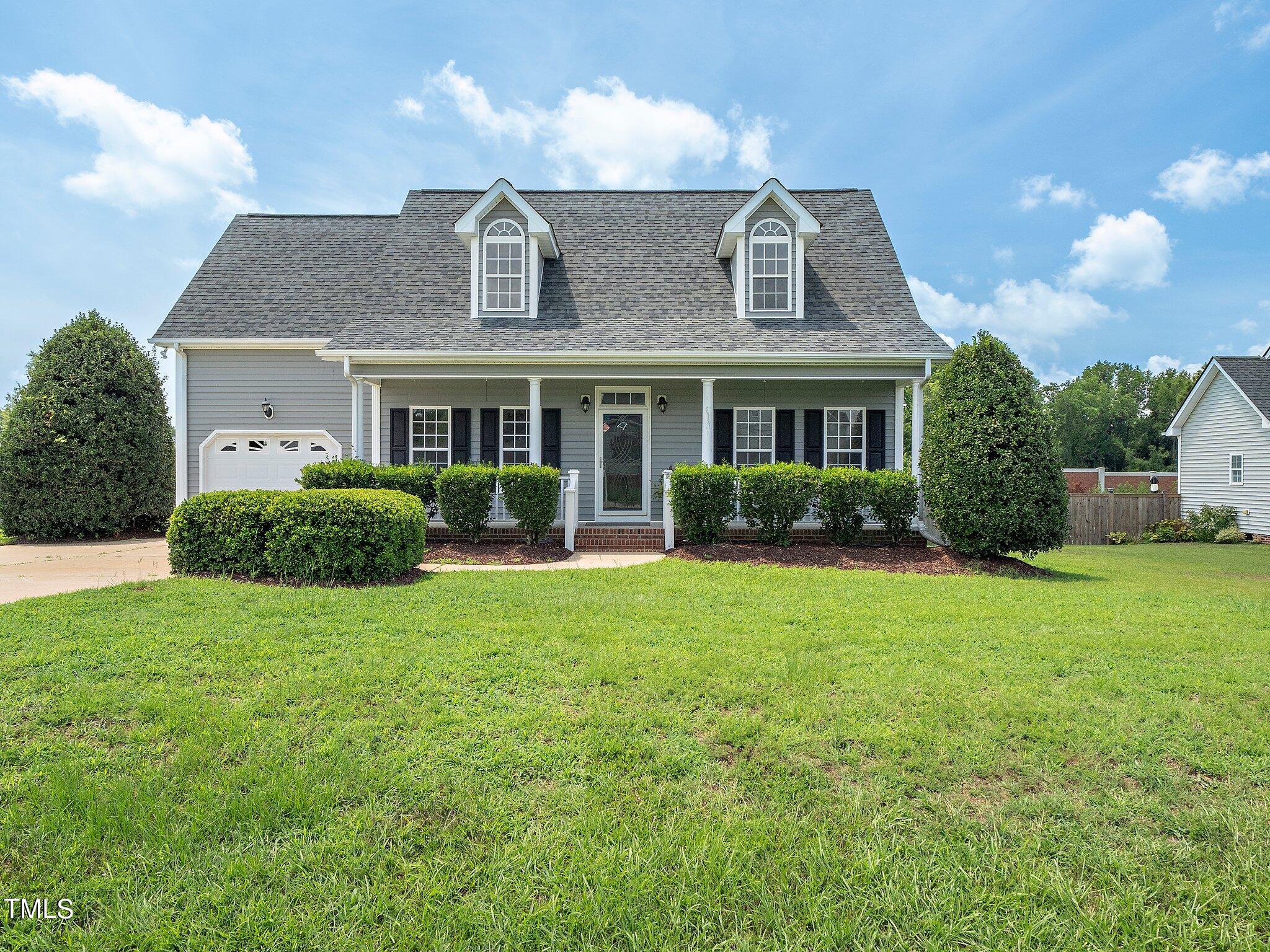 5004 Contender Drive Raleigh, NC 27603 - Photo 11 of 28 a front view of house with yard and outdoor seating