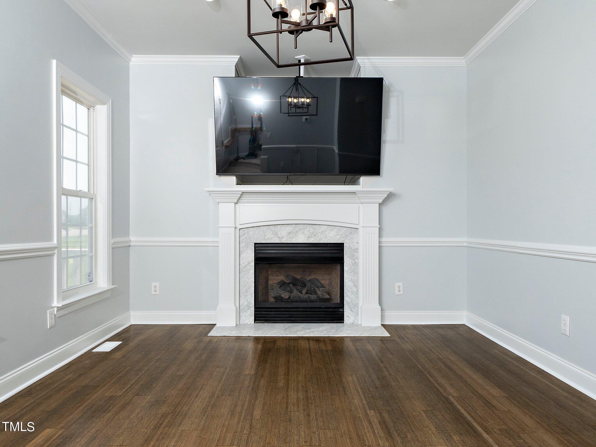 5004 Contender Drive Raleigh, NC 27603 - Photo 13 of 28 a living room with a fireplace and a flat screen tv
