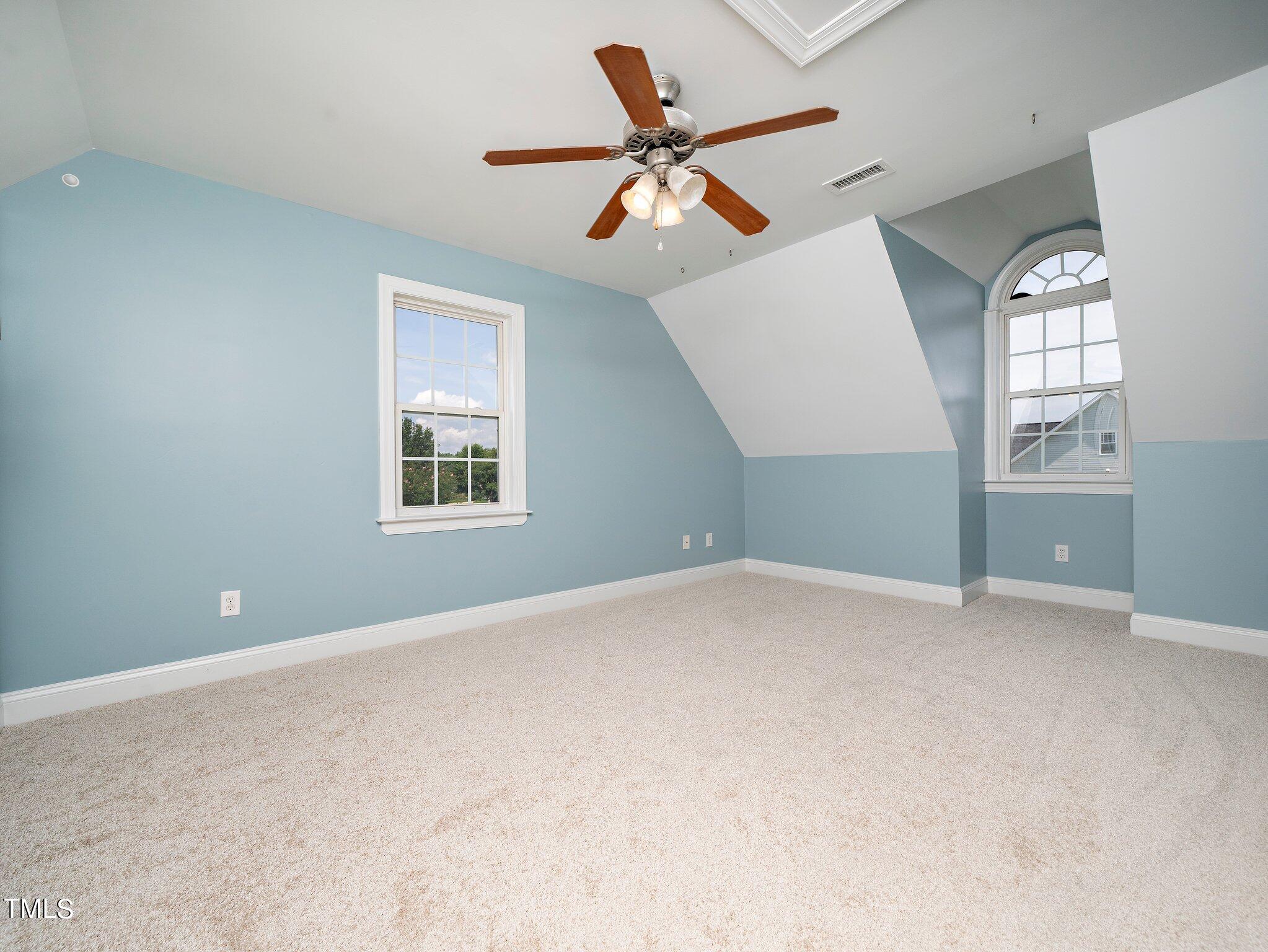 5004 Contender Drive Raleigh, NC 27603 - Photo 14 of 28 an empty room with windows and fan