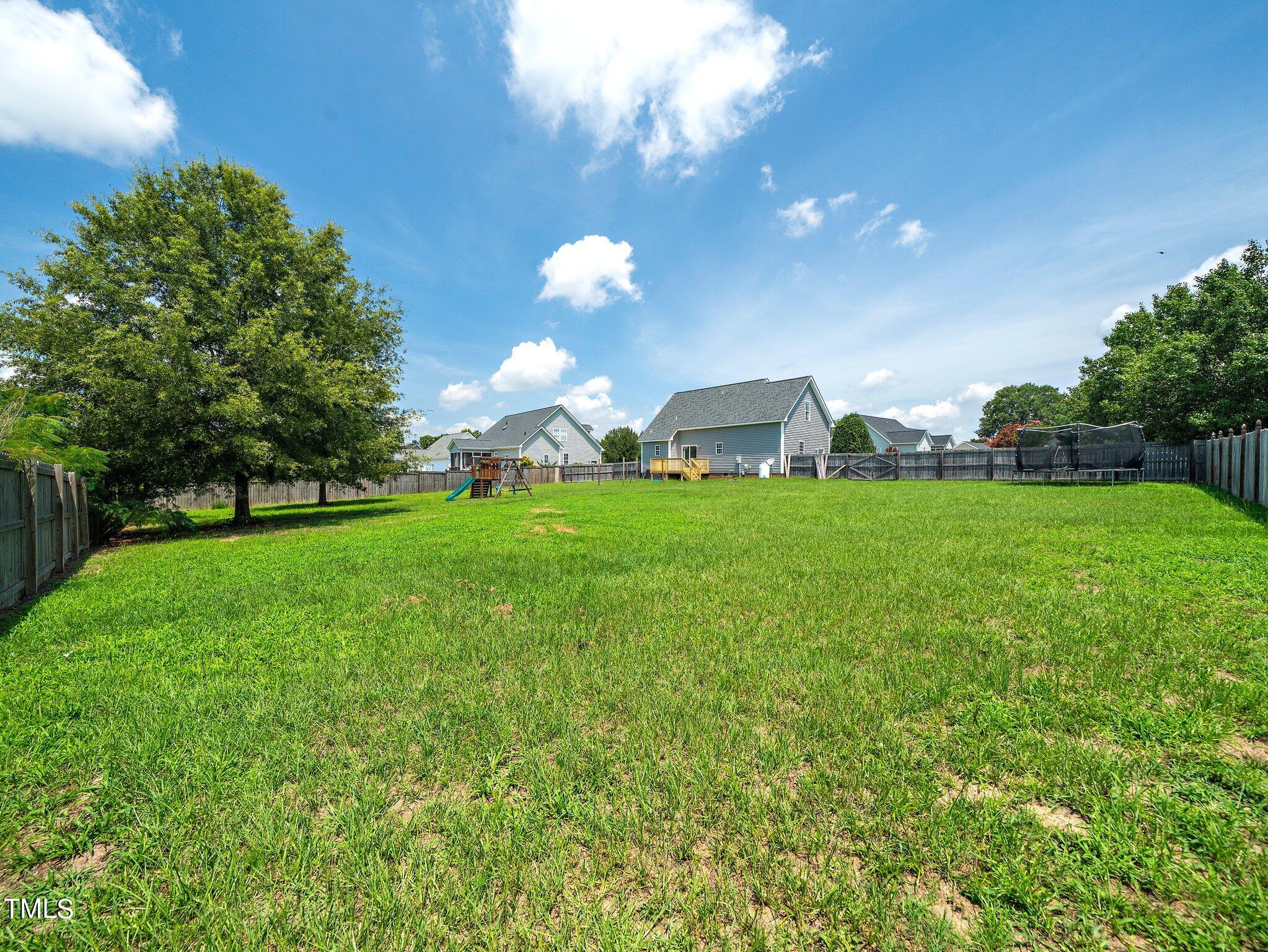 5004 Contender Drive Raleigh, NC 27603 - Photo 2 of 28 a view of a big yard with a house and garden