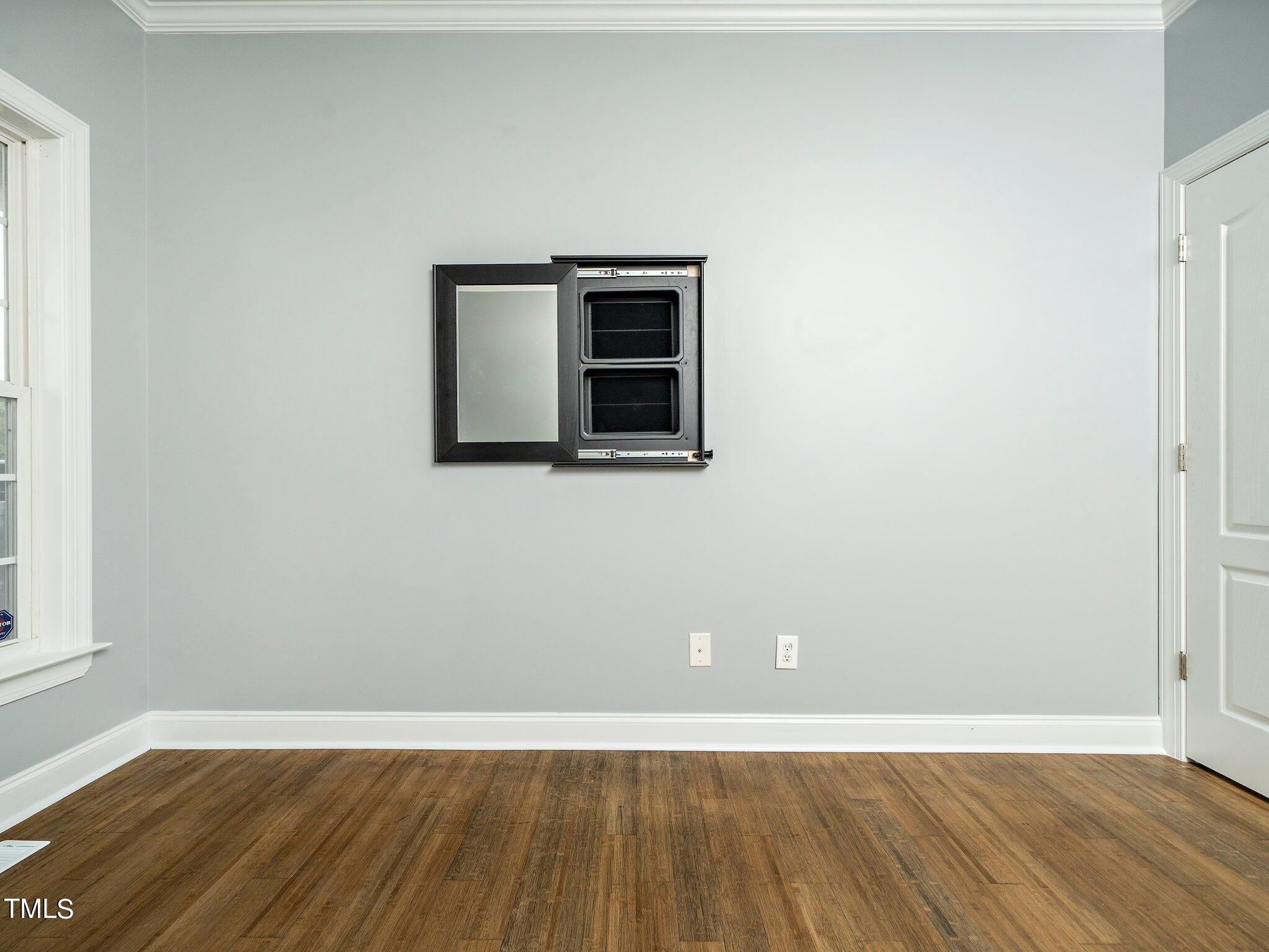 5004 Contender Drive Raleigh, NC 27603 - Photo 21 of 28 a view of an empty room with wooden floor and a window