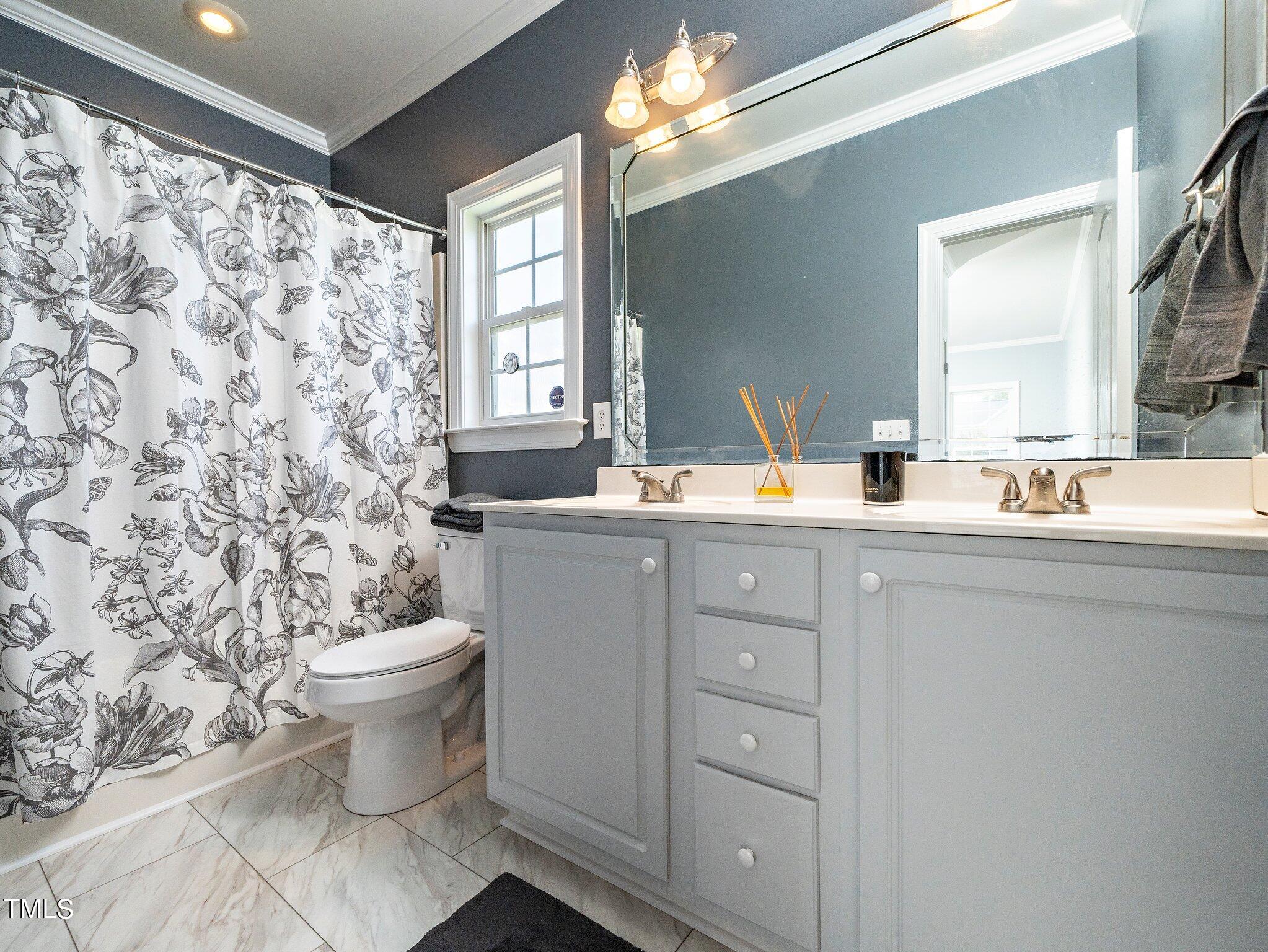 5004 Contender Drive Raleigh, NC 27603 - Photo 22 of 28 a bathroom with a toilet sink and mirror