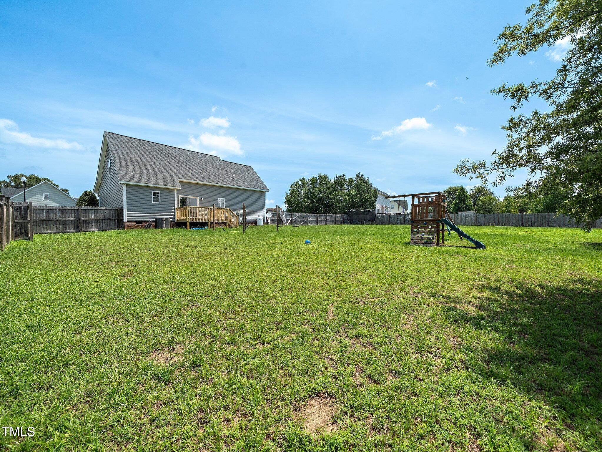 5004 Contender Drive Raleigh, NC 27603 - Photo 24 of 28 a view of a house with a big yard and large trees