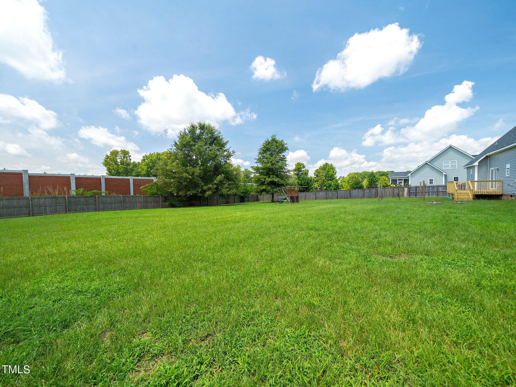 5004 Contender Drive Raleigh, NC 27603 - Photo 25 of 28 a view of a big yard with a house and a garden