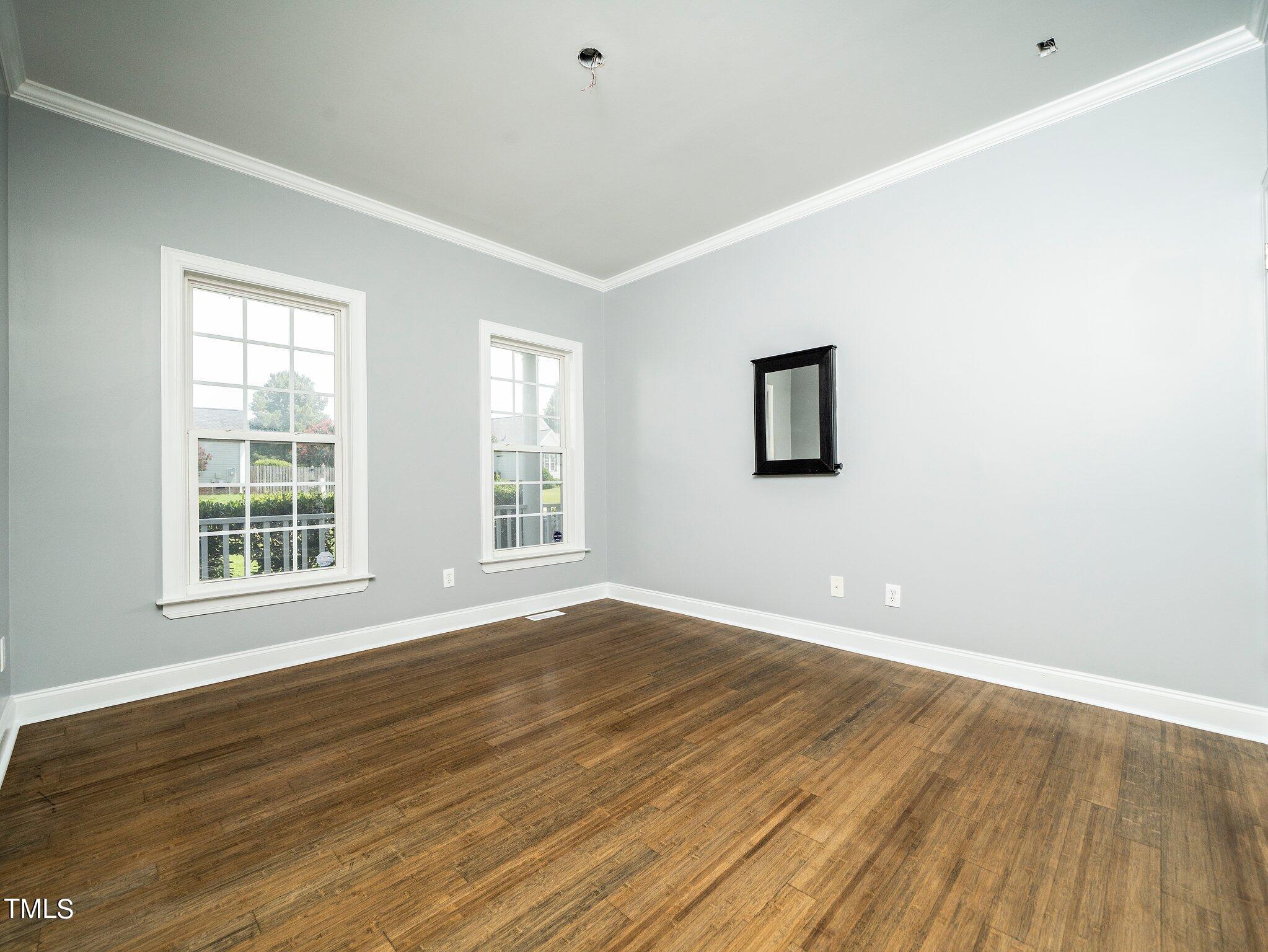 5004 Contender Drive Raleigh, NC 27603 - Photo 3 of 28 an empty room with wooden floor and windows