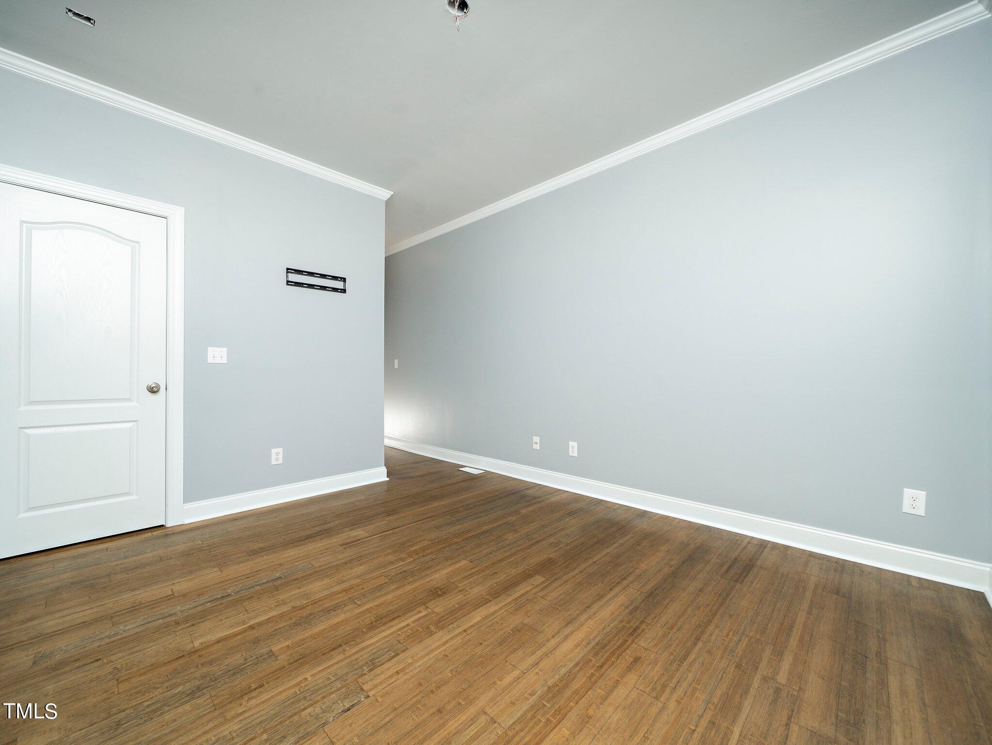 5004 Contender Drive Raleigh, NC 27603 - Photo 5 of 28 a view of an empty room with wooden floor