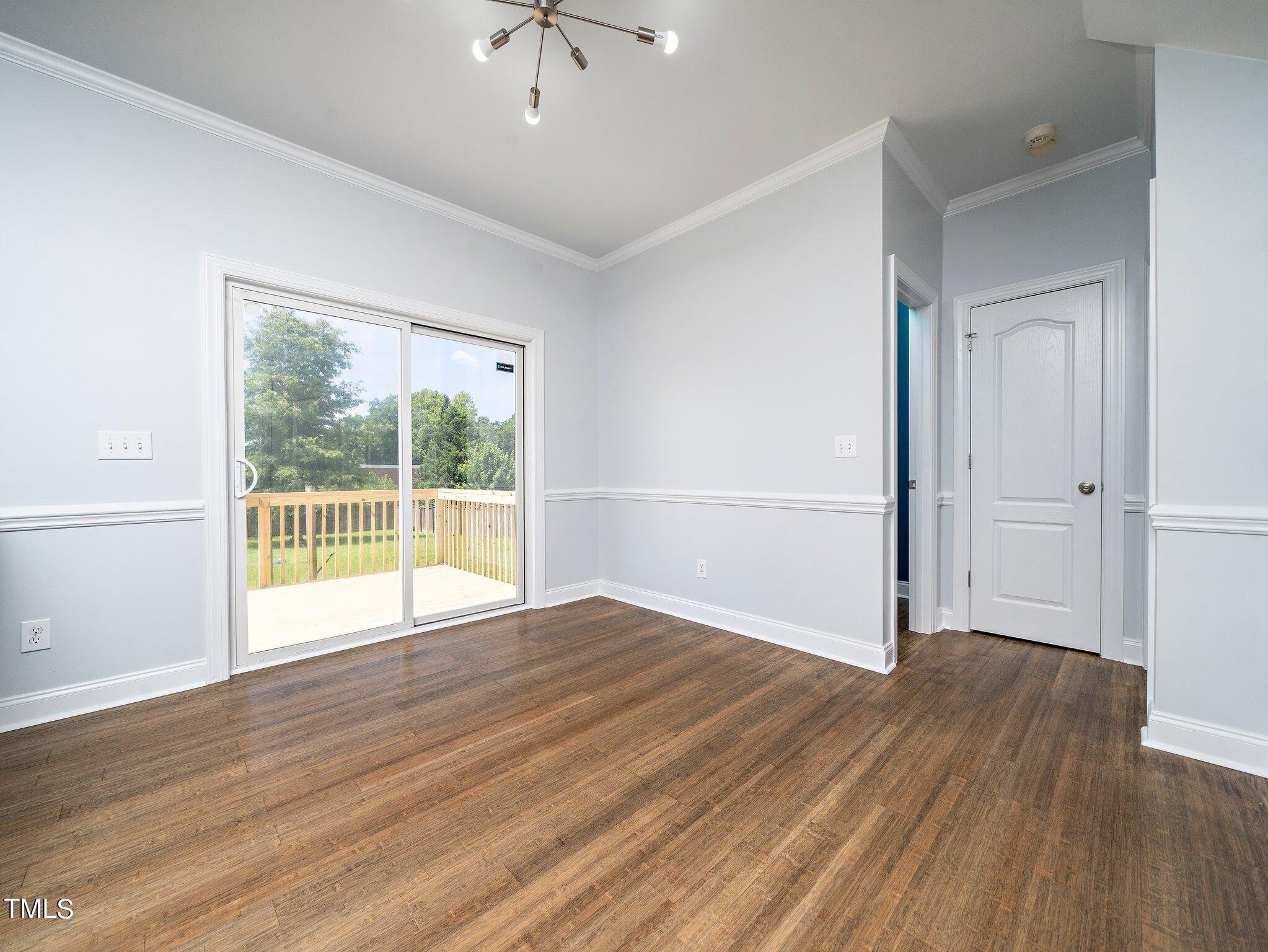 5004 Contender Drive Raleigh, NC 27603 - Photo 7 of 28 a view of an empty room with wooden floor and a window