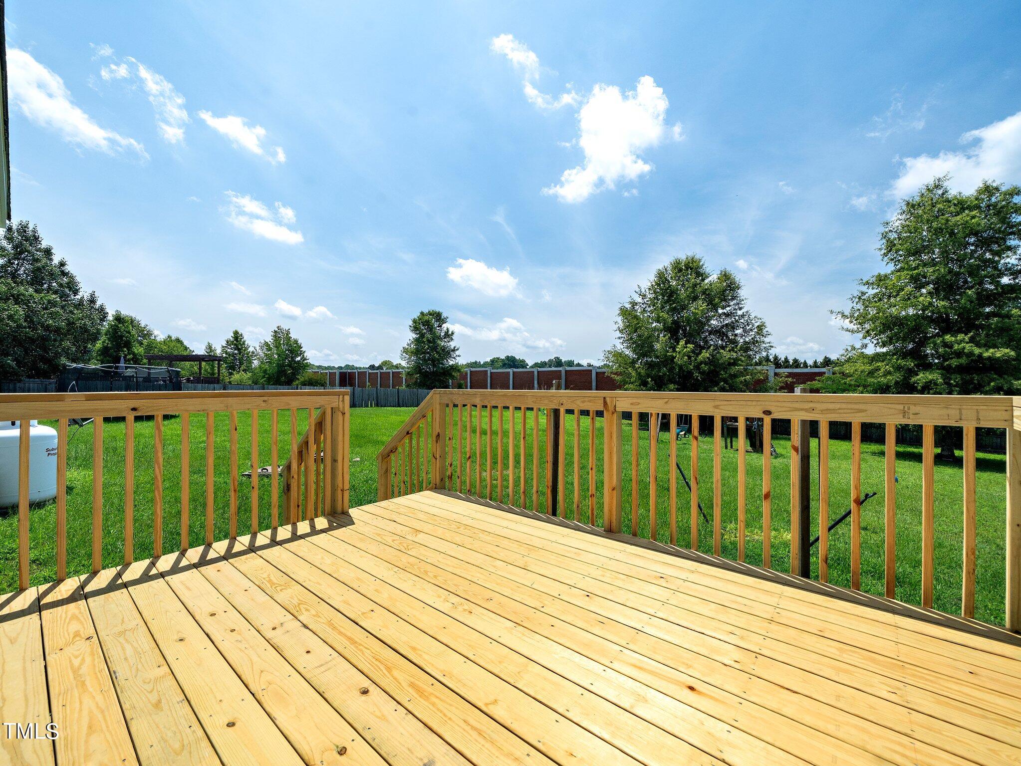 5004 Contender Drive Raleigh, NC 27603 - Photo 9 of 28 a view of balcony and deck with wooden floor and fence