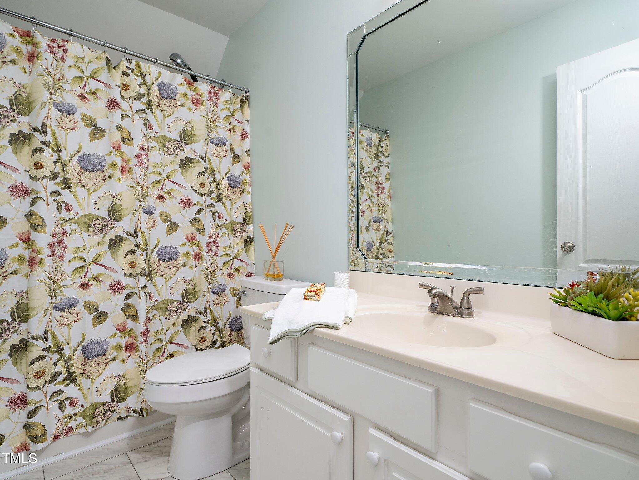 5004 Contender Drive Raleigh, NC 27603 - Photo 10 of 28 a bathroom with a sink toilet and shower