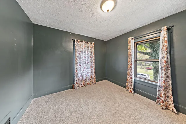 a bed room with a bed and a window