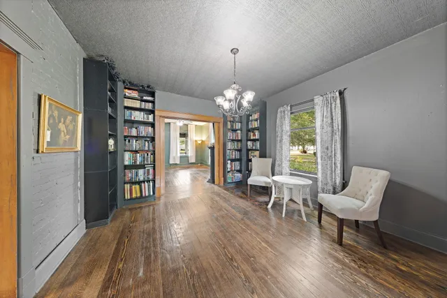 a living room with furniture and a chandelier