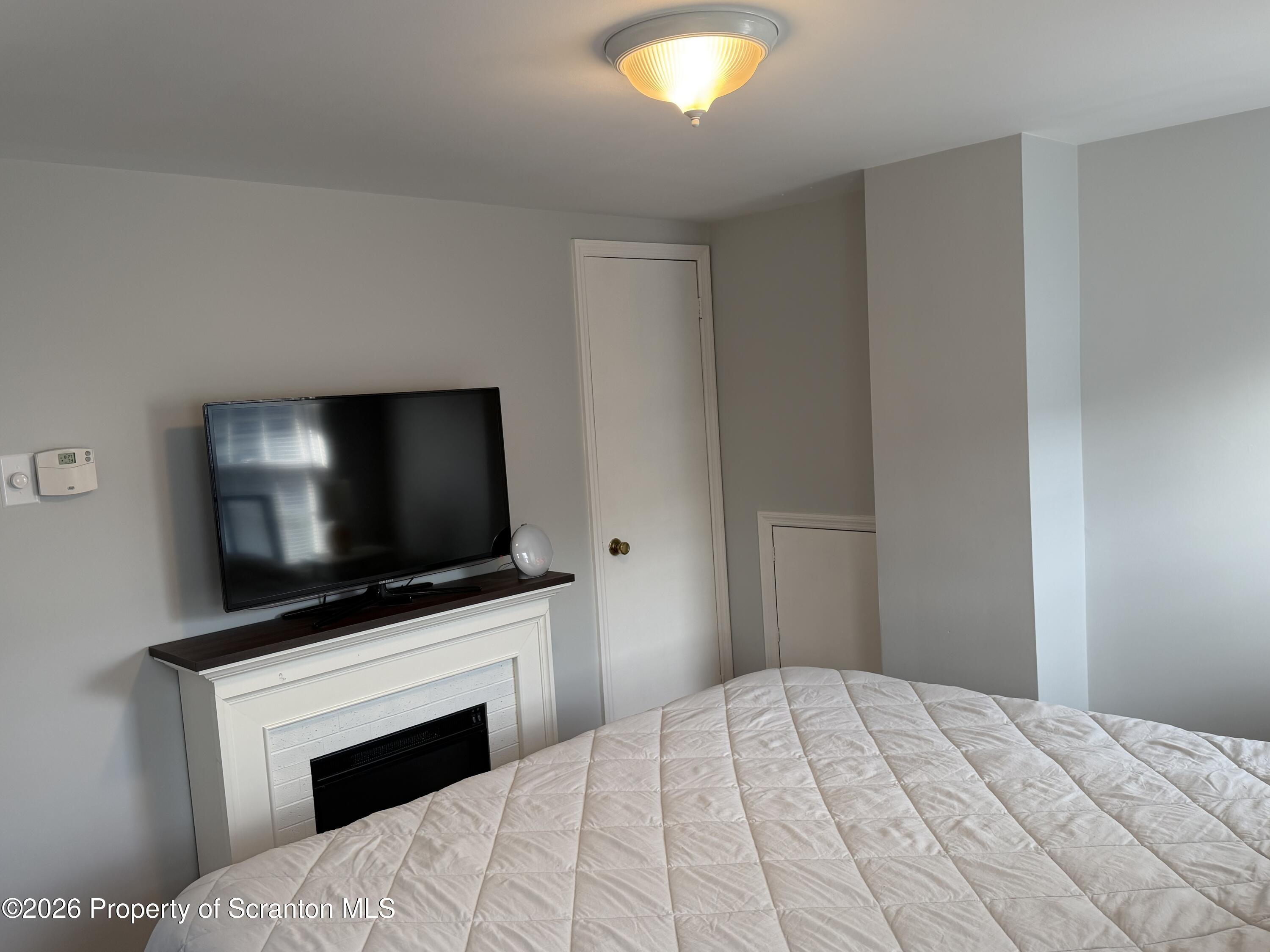 320 Haverly Street Throop, PA 18512 - Photo 16 of 27 a bedroom with a bed and a flat screen tv
