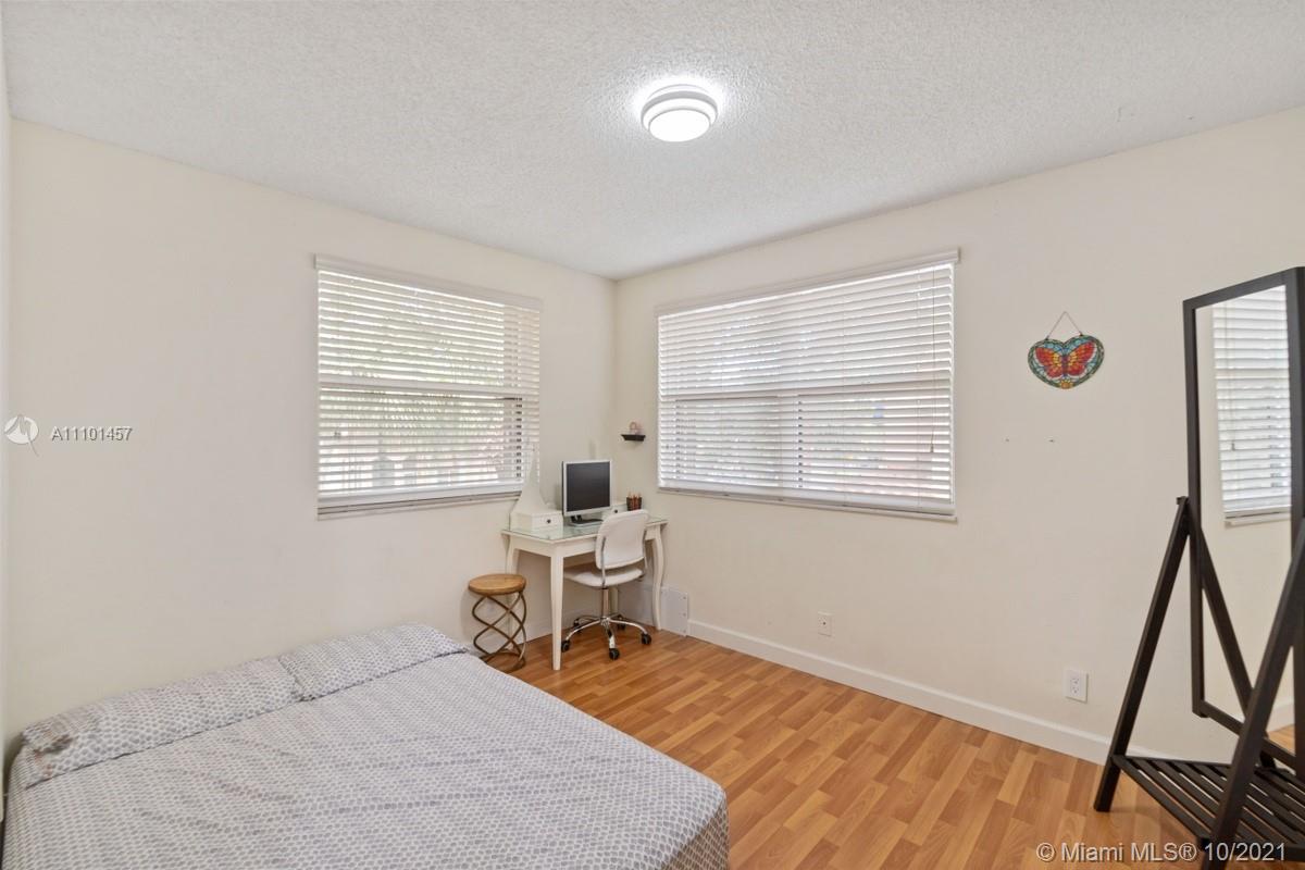 501 Racquet Club Road, Unit 61 Weston, FL 33326 - Photo 11 of 17 a bedroom with a bed and a window