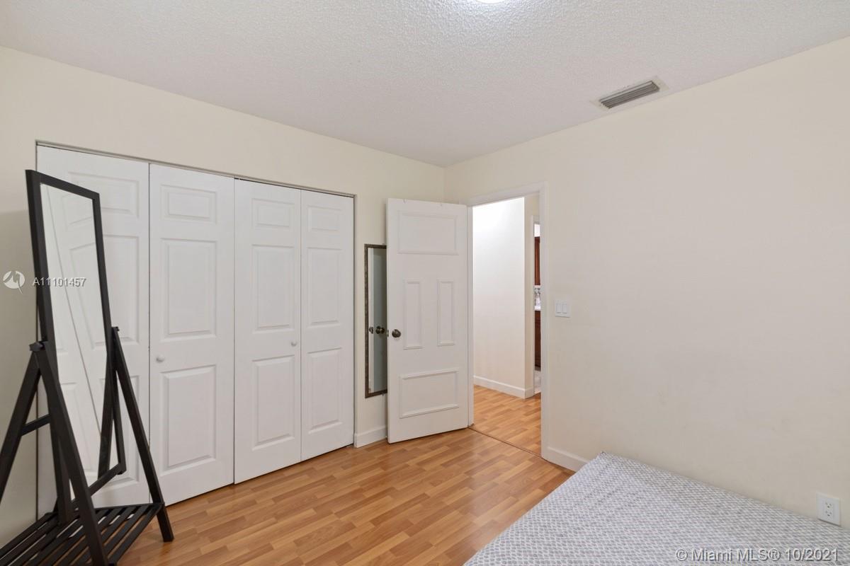 501 Racquet Club Road, Unit 61 Weston, FL 33326 - Photo 12 of 17 an empty room with wooden floor and entrance