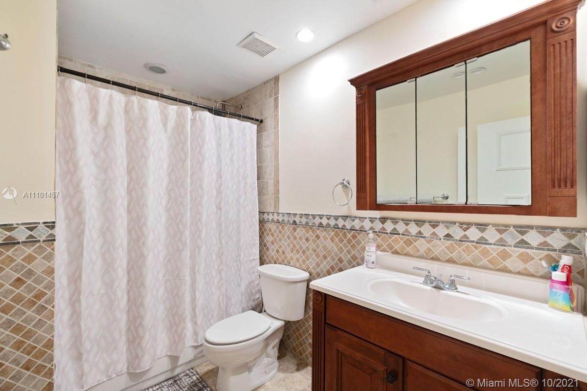 501 Racquet Club Road, Unit 61 Weston, FL 33326 - Photo 13 of 17 a bathroom with a sink and a mirror