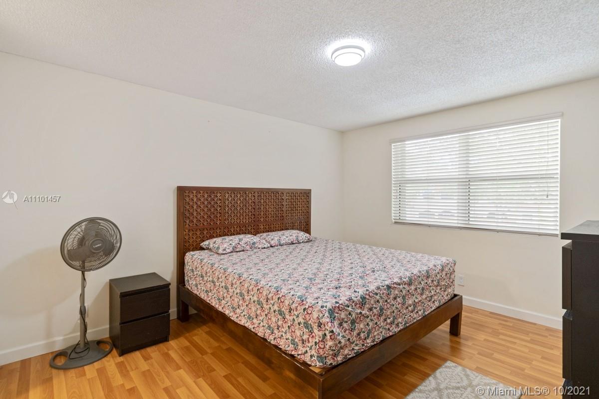 501 Racquet Club Road, Unit 61 Weston, FL 33326 - Photo 14 of 17 a bedroom with a bed and window