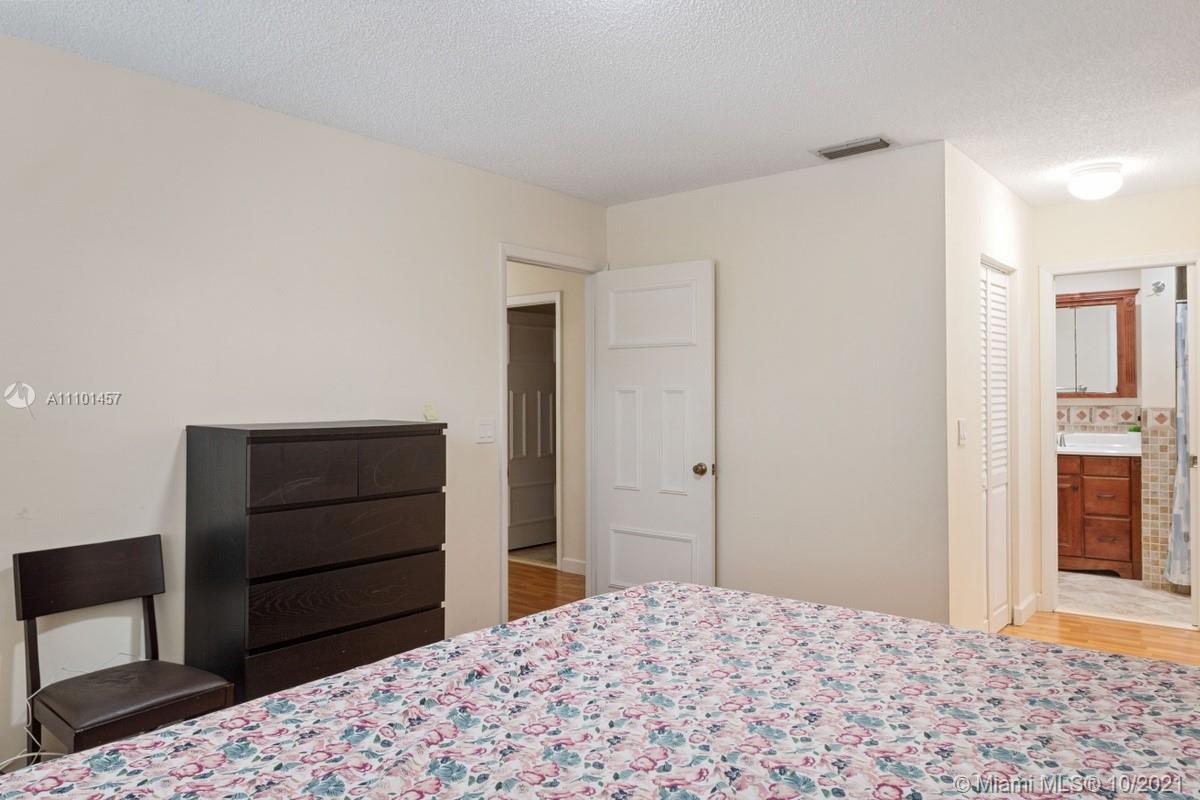 501 Racquet Club Road, Unit 61 Weston, FL 33326 - Photo 15 of 17 a bedroom with a bed and a dresser