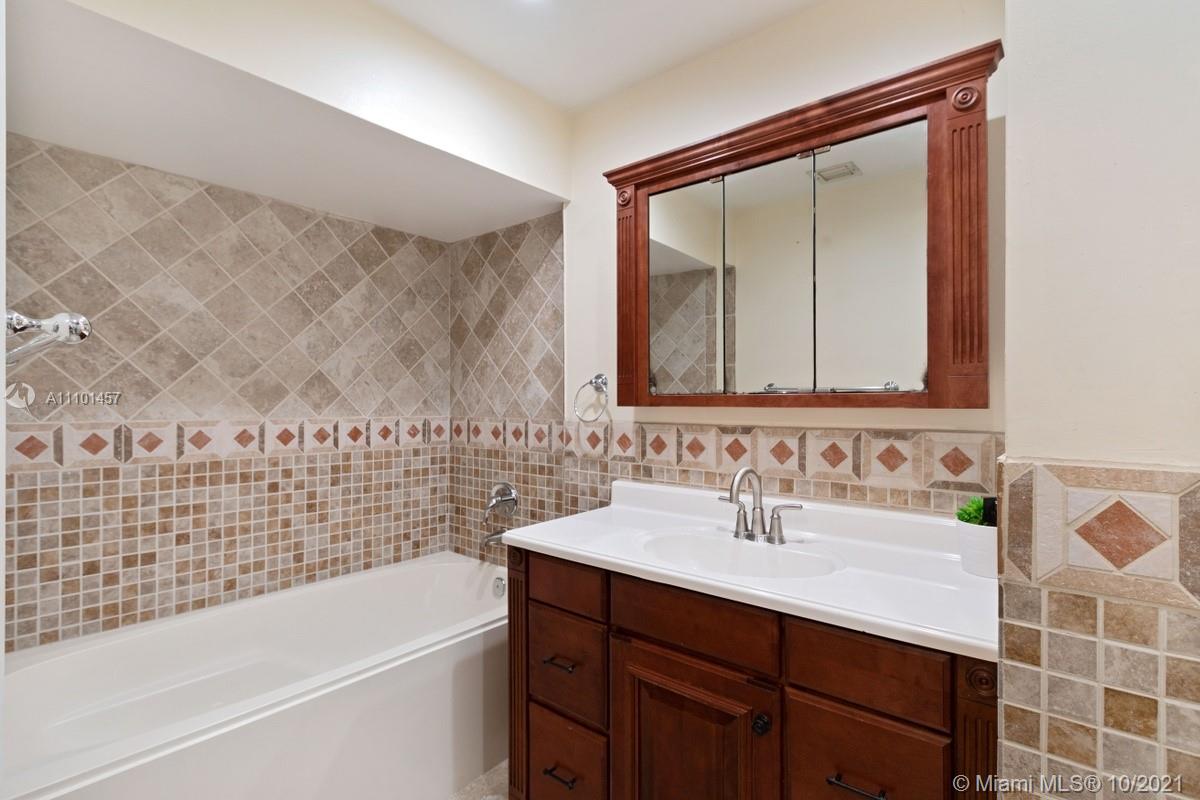 501 Racquet Club Road, Unit 61 Weston, FL 33326 - Photo 16 of 17 a bathroom with a sink and a mirror