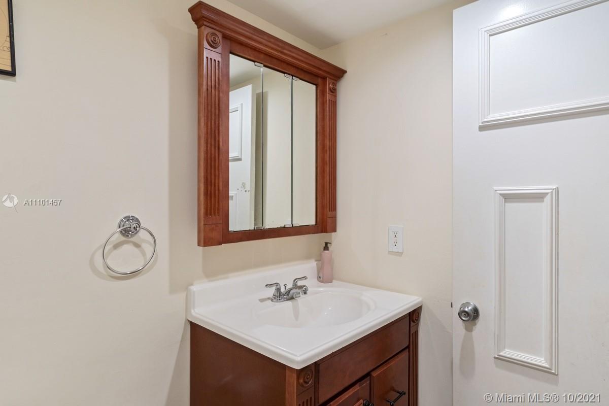 501 Racquet Club Road, Unit 61 Weston, FL 33326 - Photo 9 of 17 a bathroom with a sink and a mirror