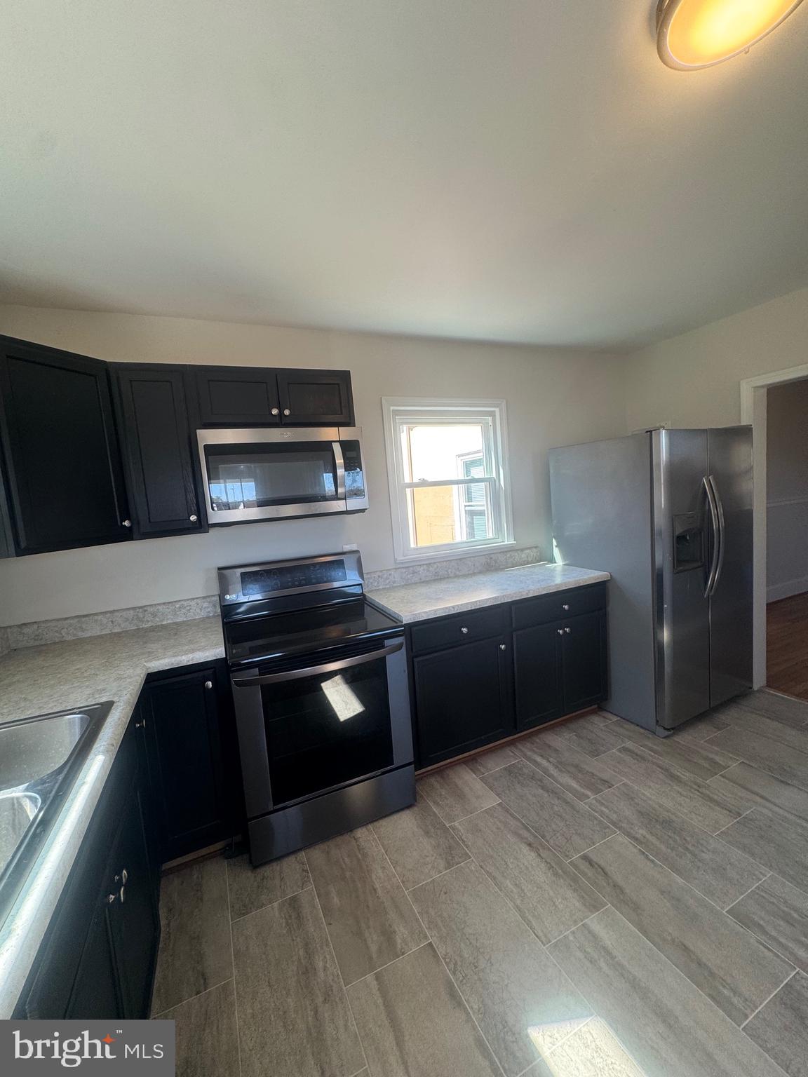 11360 Ridge Road King George, VA 22485 - Photo 21 of 39 a kitchen with granite countertop a refrigerator and a stove