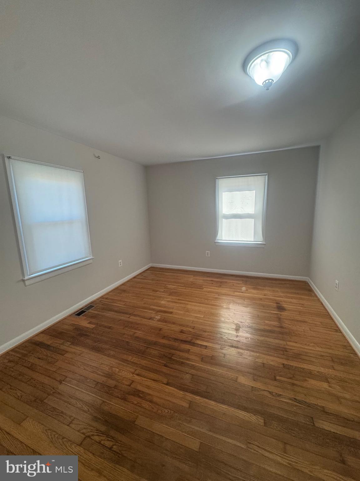 11360 Ridge Road King George, VA 22485 - Photo 32 of 39 an empty room with wooden floor and windows