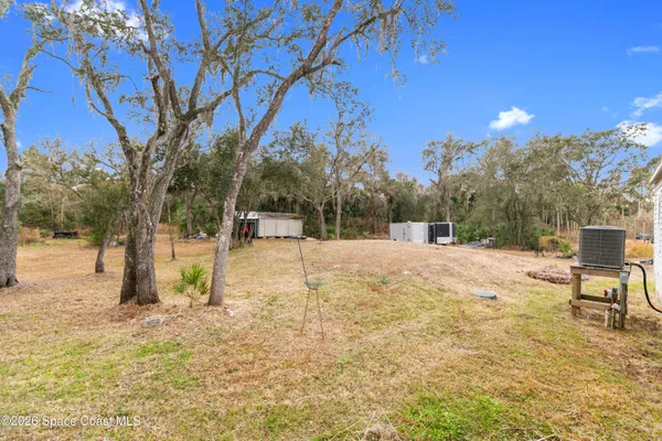 a view of outdoor space with trees in the background