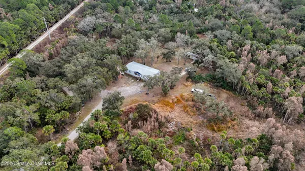 an aerial view of a house with a yard