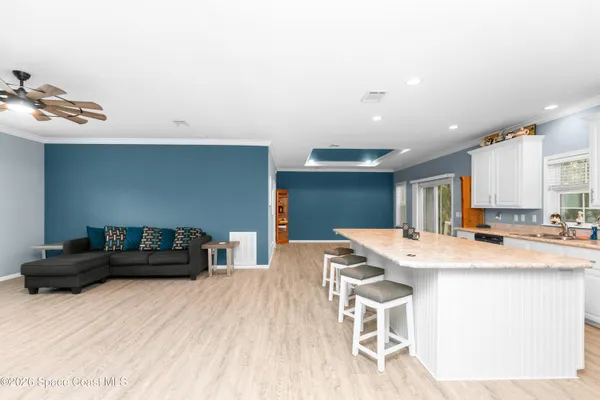 a kitchen with a table chairs and a refrigerator