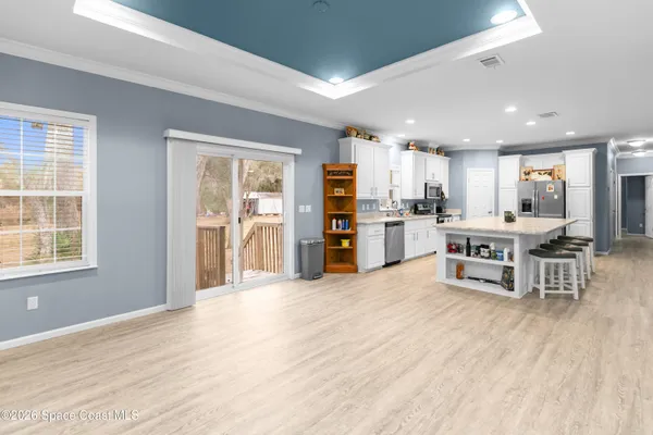 a large kitchen with stainless steel appliances lots of counter space and windows