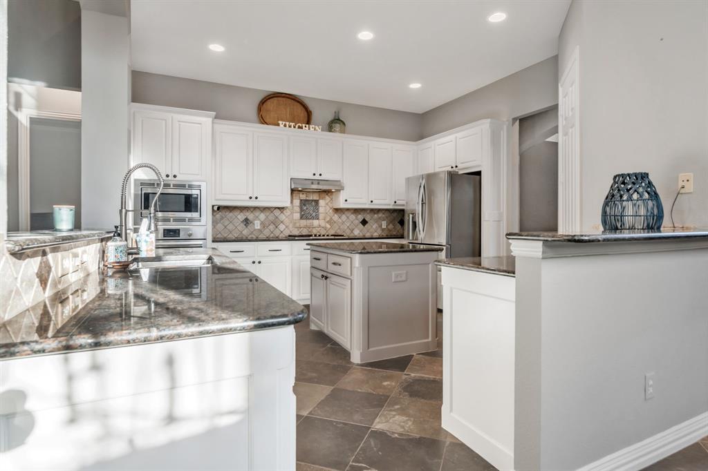 508 Cypress Court Keller, TX 76248 - Photo 12 of 40 a kitchen with stainless steel appliances granite countertop a sink stove and refrigerator