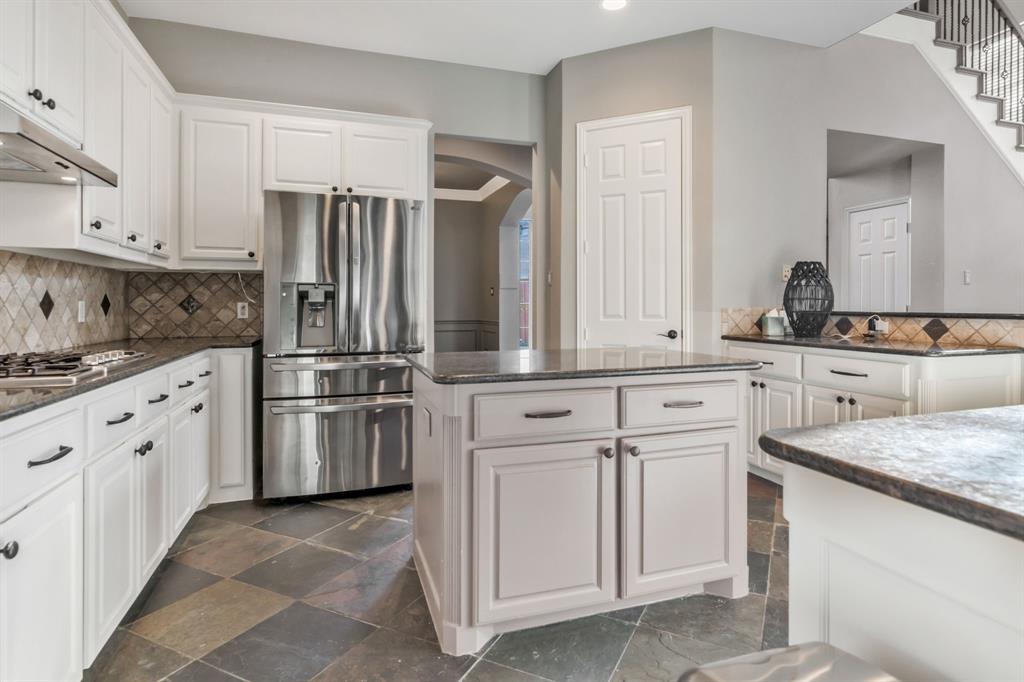 508 Cypress Court Keller, TX 76248 - Photo 14 of 40 a kitchen with white cabinets and stainless steel appliances