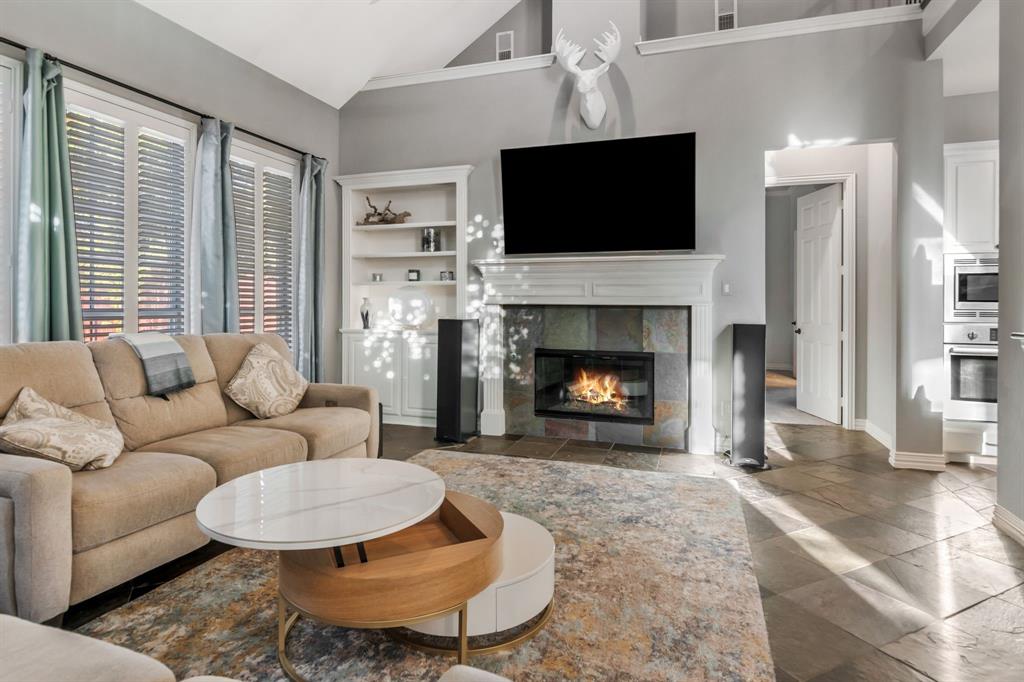 508 Cypress Court Keller, TX 76248 - Photo 16 of 40 a living room with furniture a fireplace and a flat screen tv