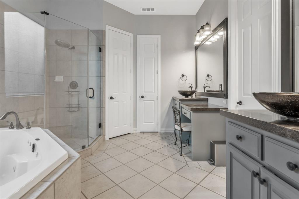 508 Cypress Court Keller, TX 76248 - Photo 21 of 40 a bathroom with a granite countertop sink mirror and a bathtub
