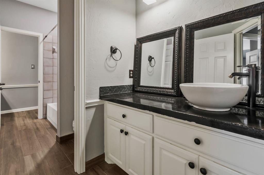 508 Cypress Court Keller, TX 76248 - Photo 35 of 40 a spacious bathroom with a granite countertop sink and a mirror