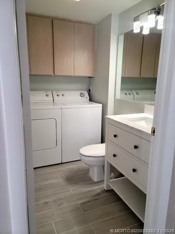 a bathroom with a sink toilet and mirror