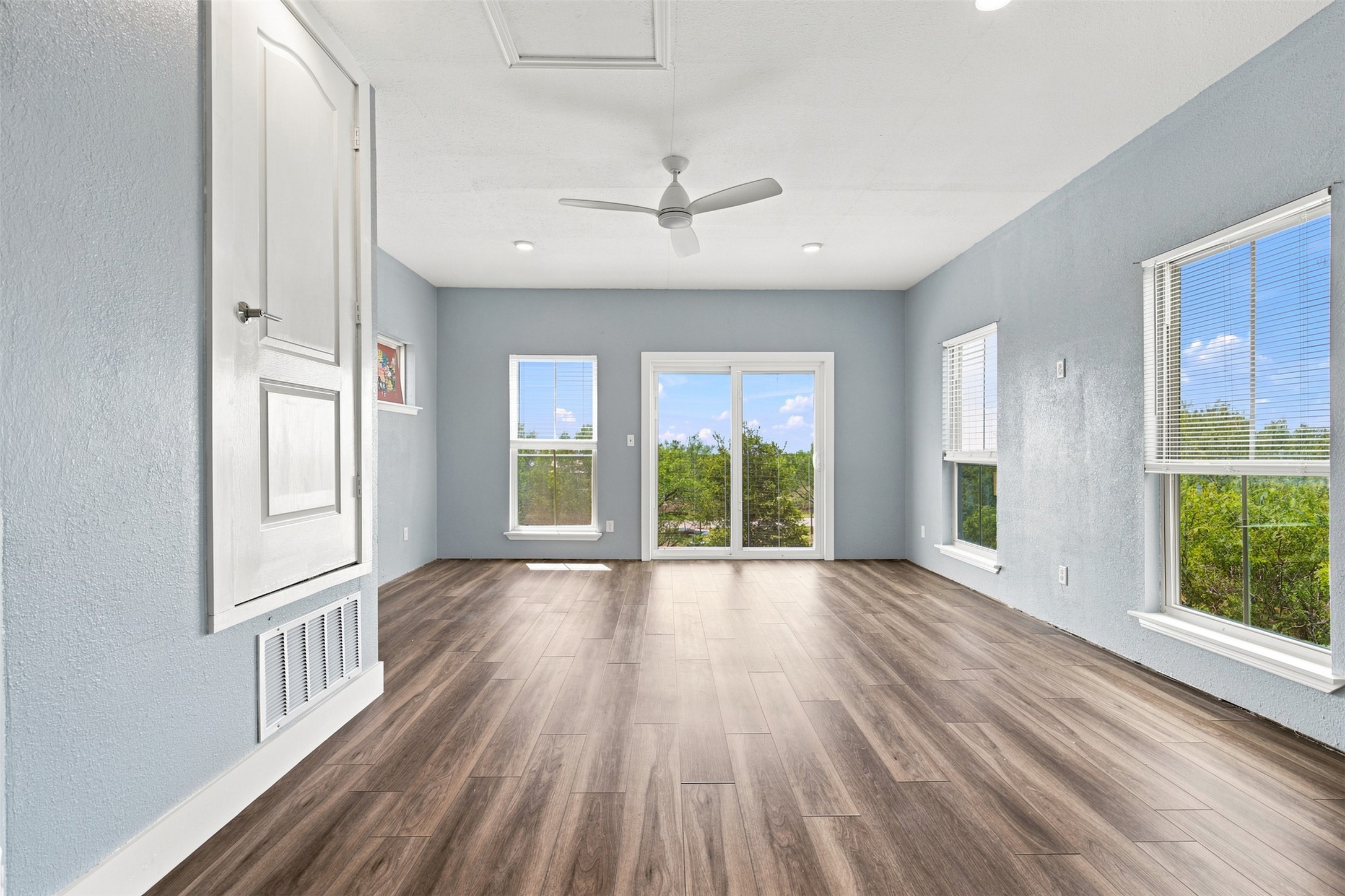 600 Highland Ranch Way Dale, TX 78616 - Photo 9 of 13 A spacious flex room features large windows for abundant natural light and a ceiling fan.